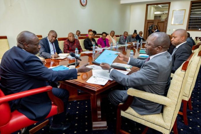 Deputy President Rigathi Gachagua receives documents from Cabinet Secretary for the Cooperatives & Micro, Small and Medium Enterprises (MSME) Development Simon Chelugui during a meeting with coffee stakeholders