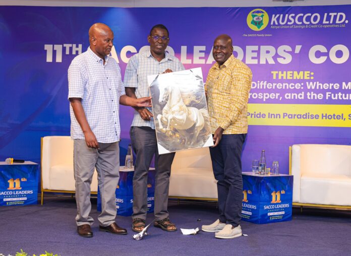 From right, Kuscco Chairman David Mategwa, David Obonyo, Commissiner Cooperatives and CPA Peter Wanjohi Kiama, Acting KUSCCO MD, Co-op News magazine